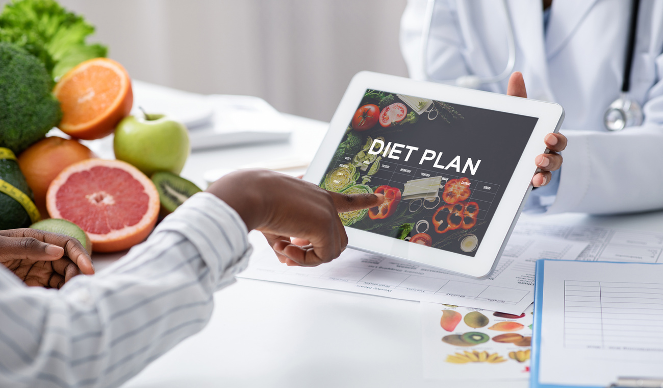 Dietologist Doctor Holding Digital Tablet With Diet Plan App, Patient Choosing Nutrition